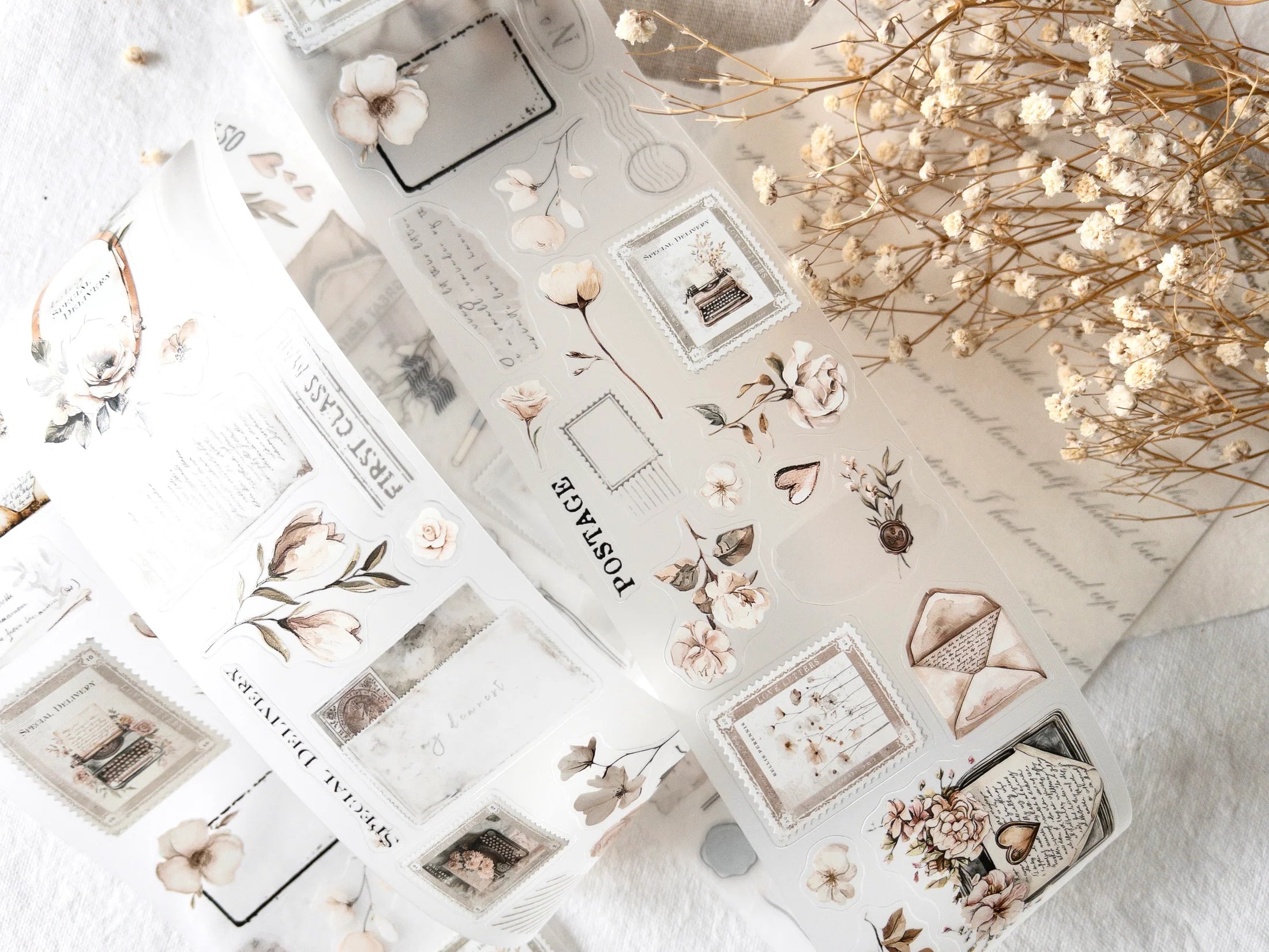 Collection of decorative stickers with floral and letter designs on a textured surface.