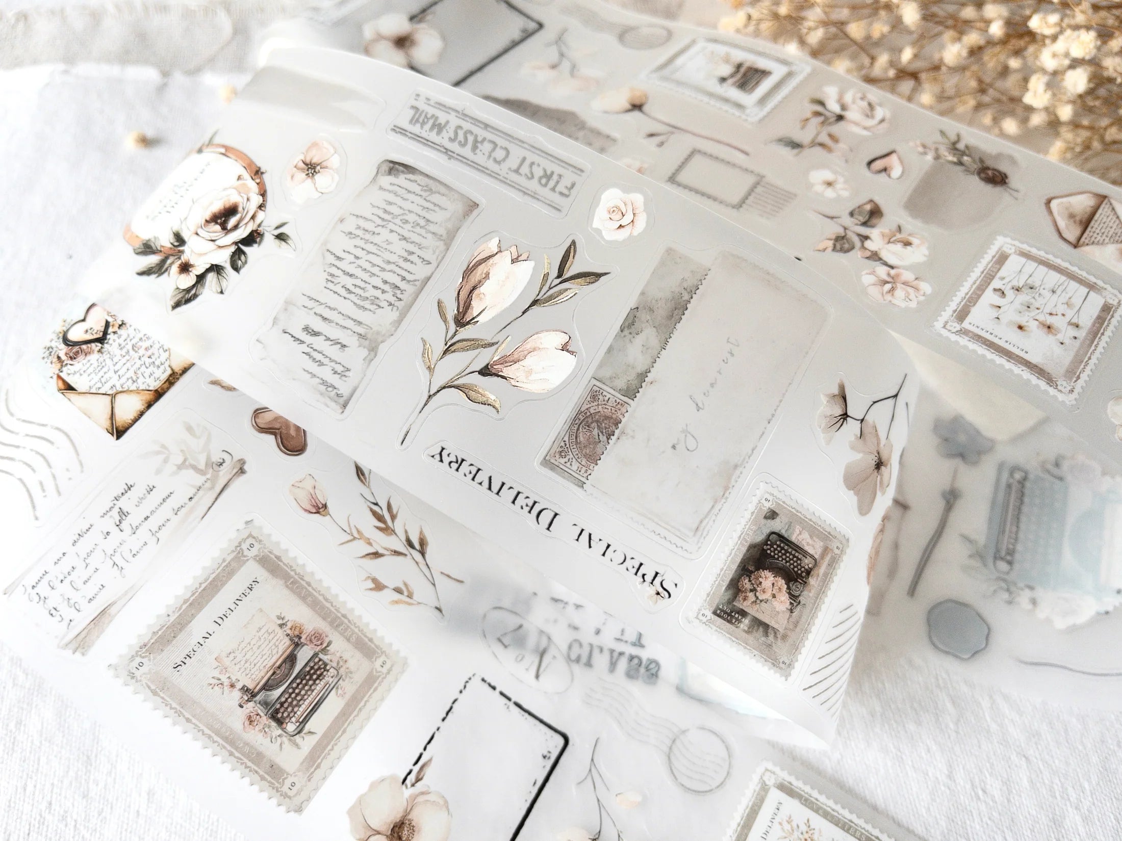 Collection of floral and decorative stationery stickers on a white surface with blurred background