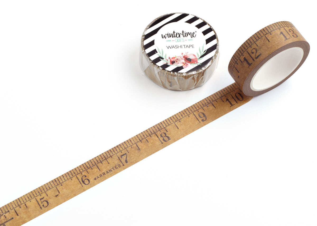 A roll of washi tape with a wooden measuring ruler design that extends diagonally across a white background.