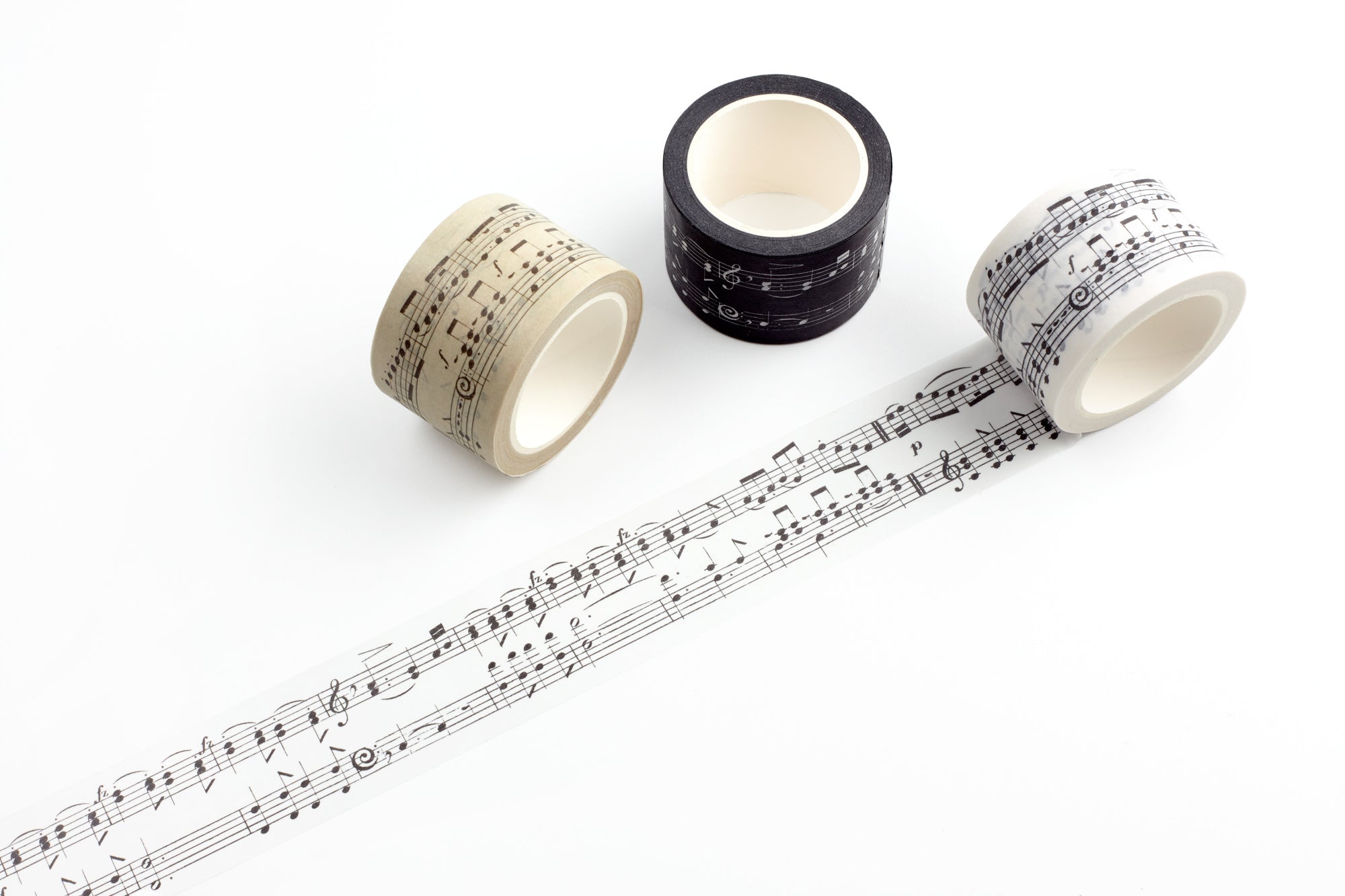 Three rolls of washi tape with musical note designs on a white background