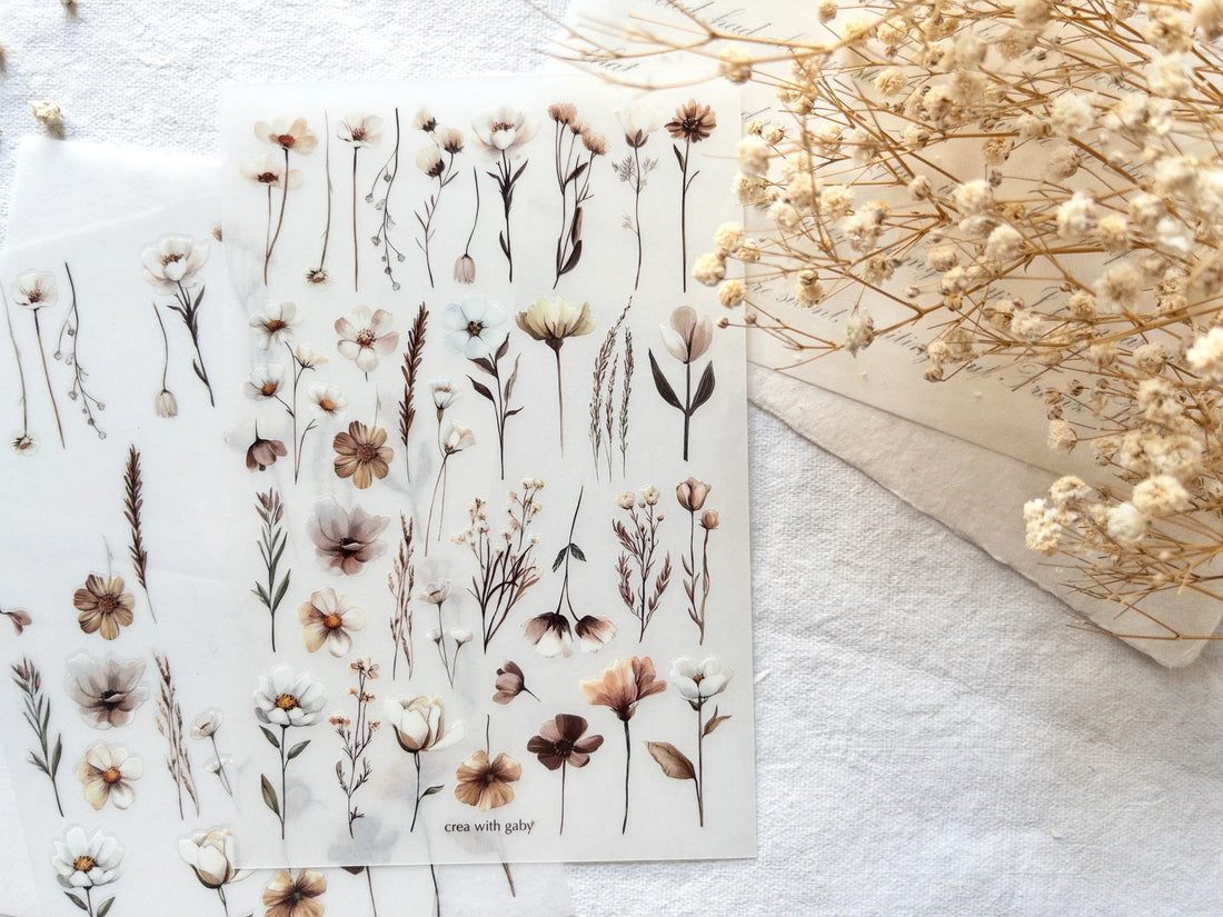 Sheet of floral stickers with dried flowers on a white surface
