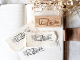 Vintage-style wood stamp with a distressed-look first class mail design