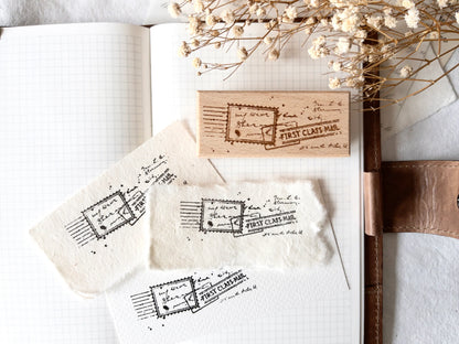 Vintage-style wood stamp with a distressed-look first class mail design