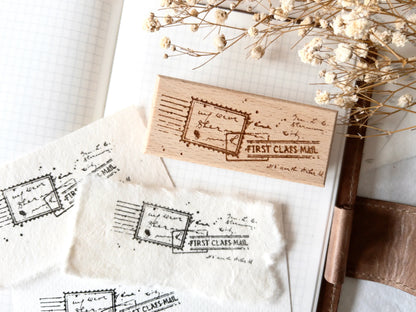 Vintage-style wood stamp with a distressed-look first class mail design
