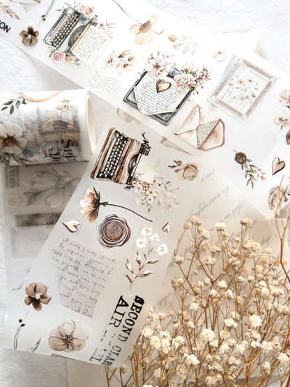 Decorative stickers with typewriter and flower designs on a white surface.