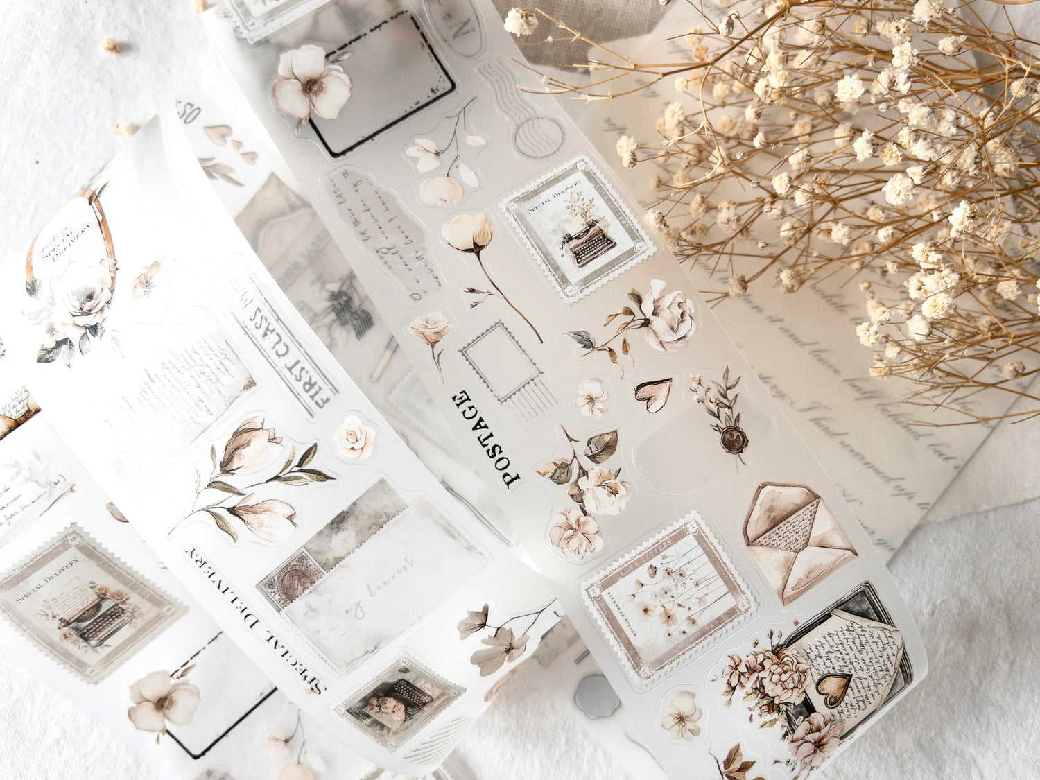 Collection of decorative stickers with floral and letter designs on a textured surface.