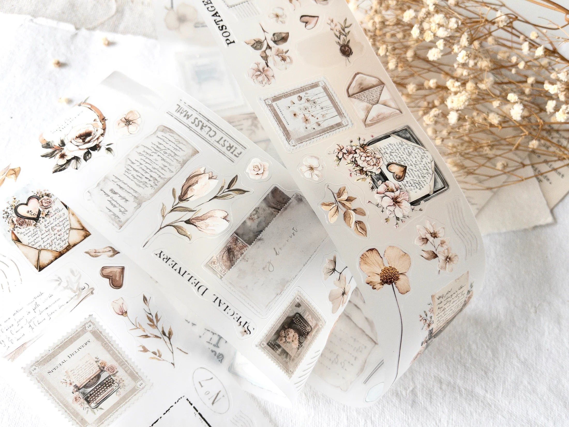 Collection of decorative pre-cut stickers with floral and vintage designs on a white surface.