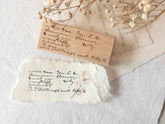 Wood-mounted stamp with vintage script text