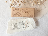 Wood-mounted stamp with vintage script text