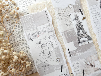 Decorative washi tape with vintage Eiffel Tower designs on a white surface with dried flowers.