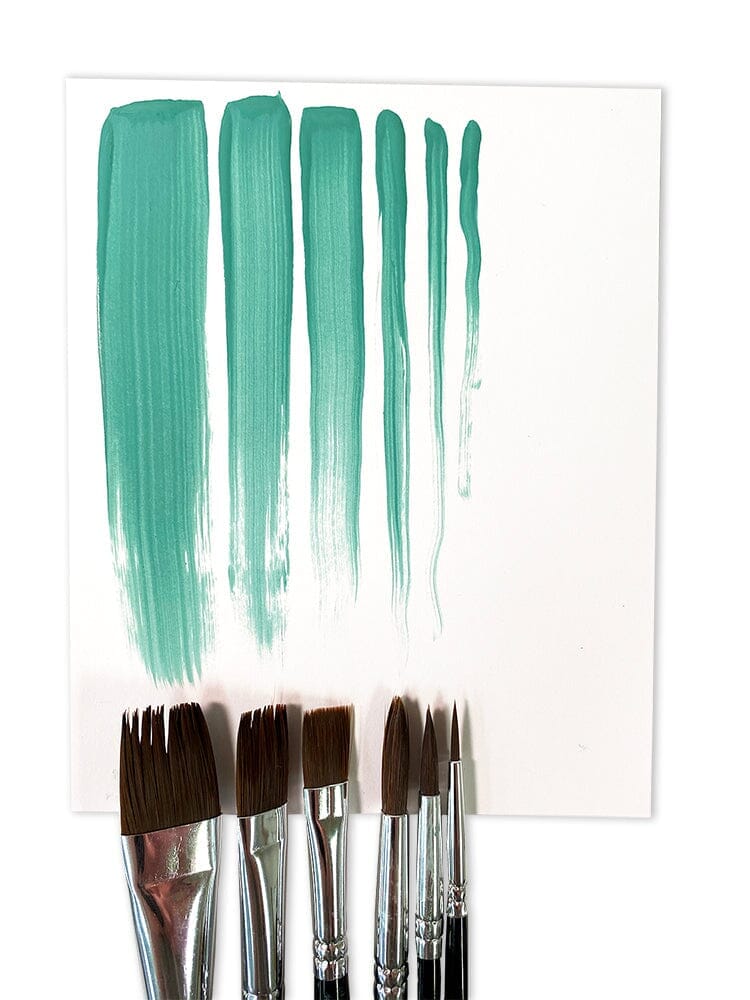 Six paintbrushes with silver and black handles are lined up below a white sheet of paper showing six vertical swatches of teal-green paint in different brush stroke widths.