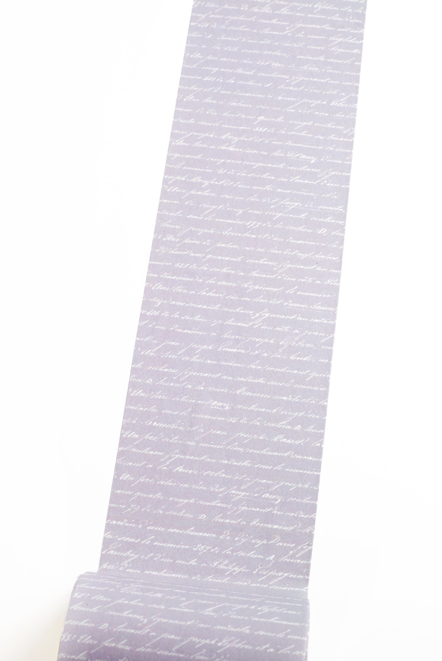 Washi tape with French script text on purple background on a white background