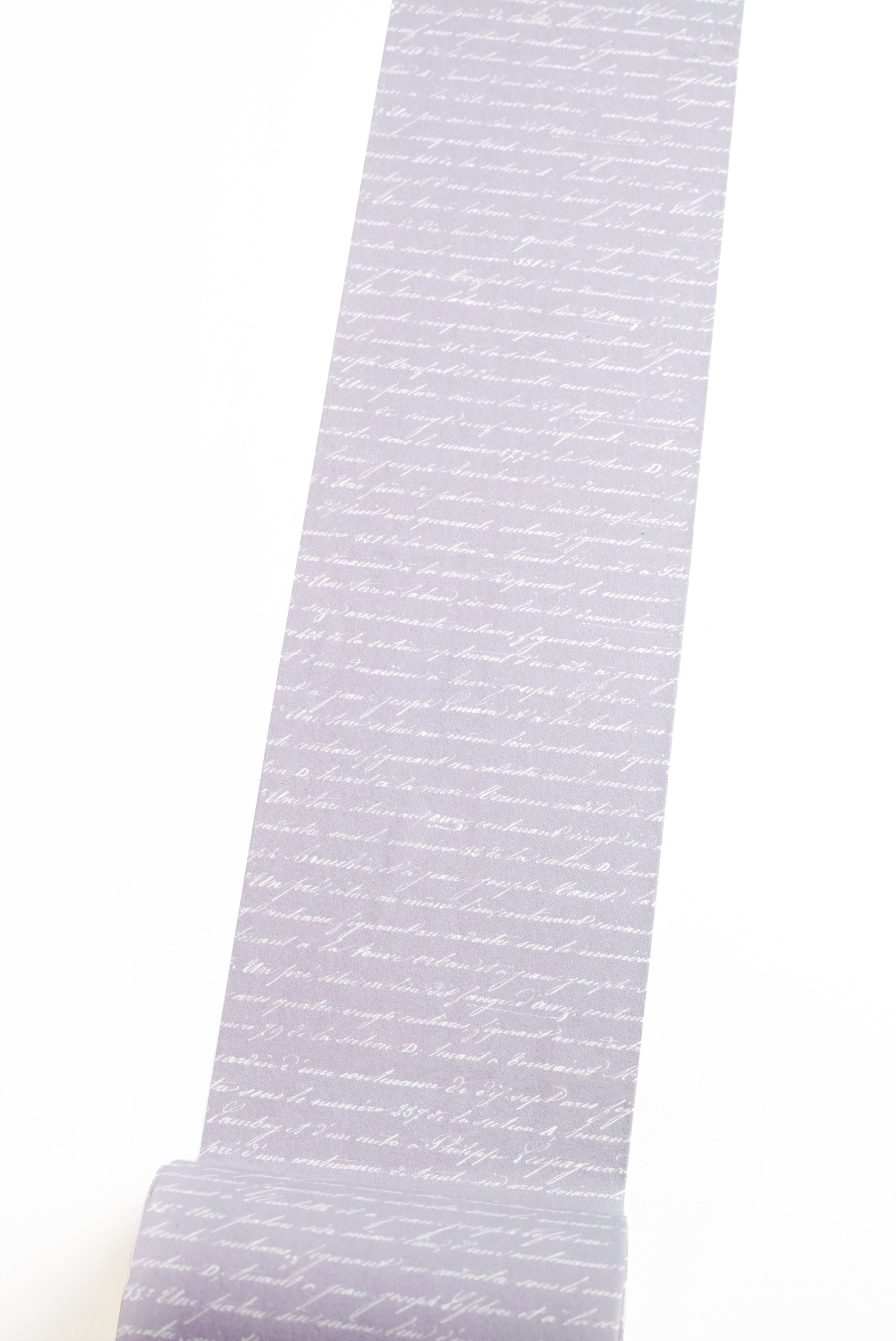Washi tape with French script text on purple background on a white background