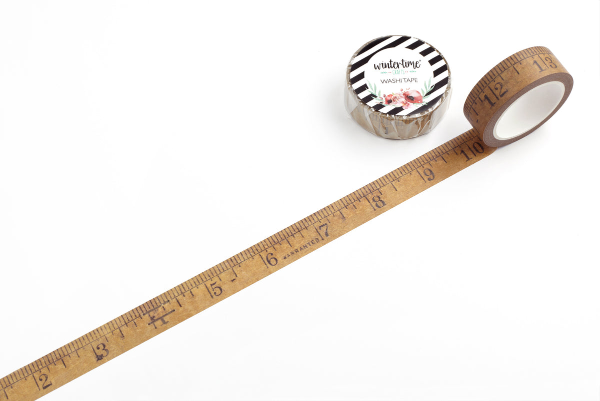 A roll of washi tape with a wooden measuring ruler design that extends diagonally across a white background.