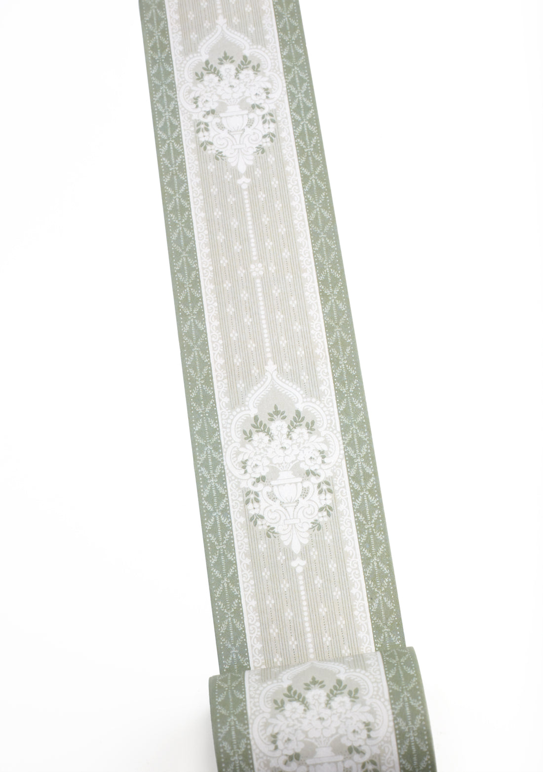A roll of sage green and white patterned washi tape shown against a plain white background.