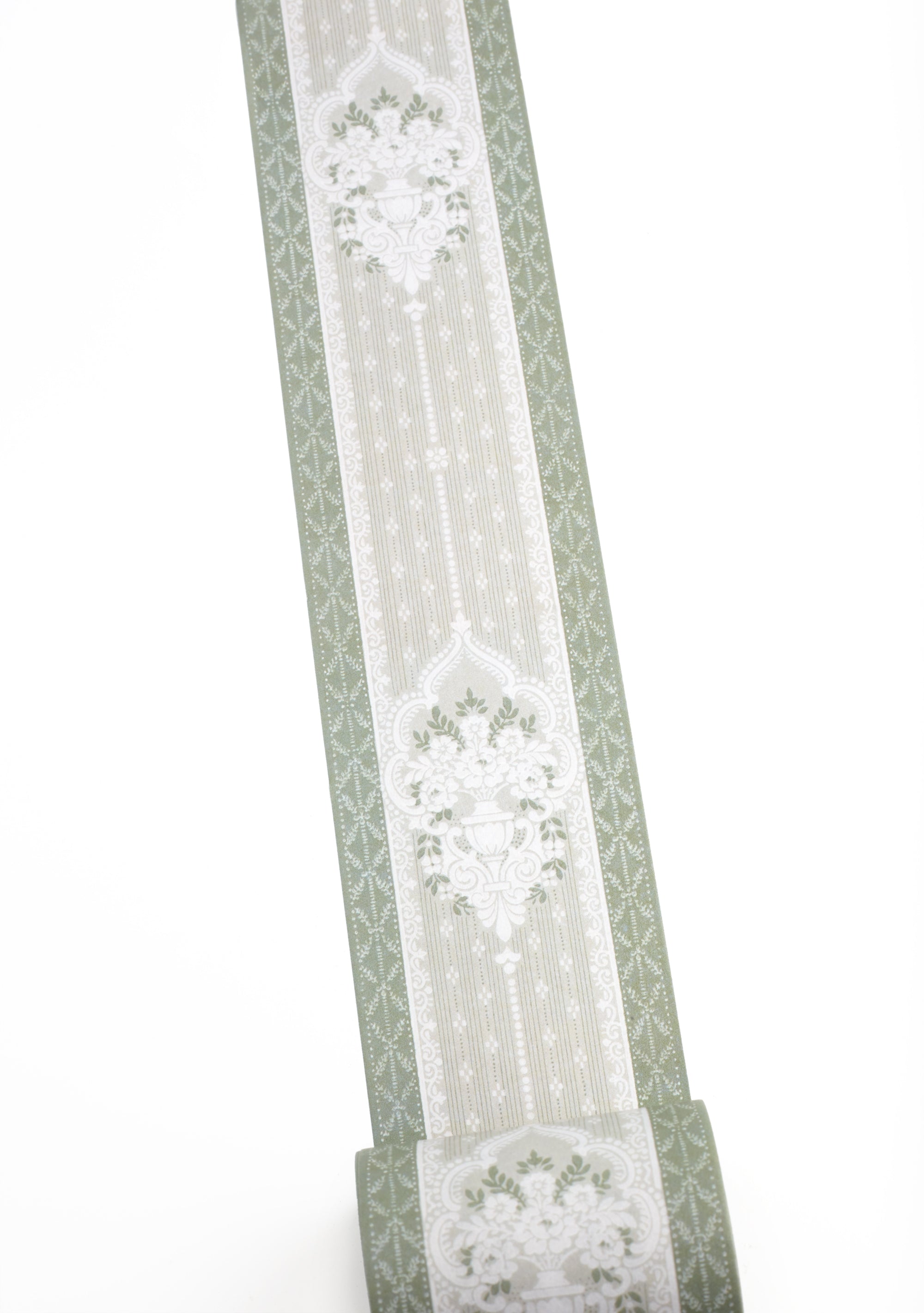 A roll of sage green and white patterned washi tape shown against a plain white background.