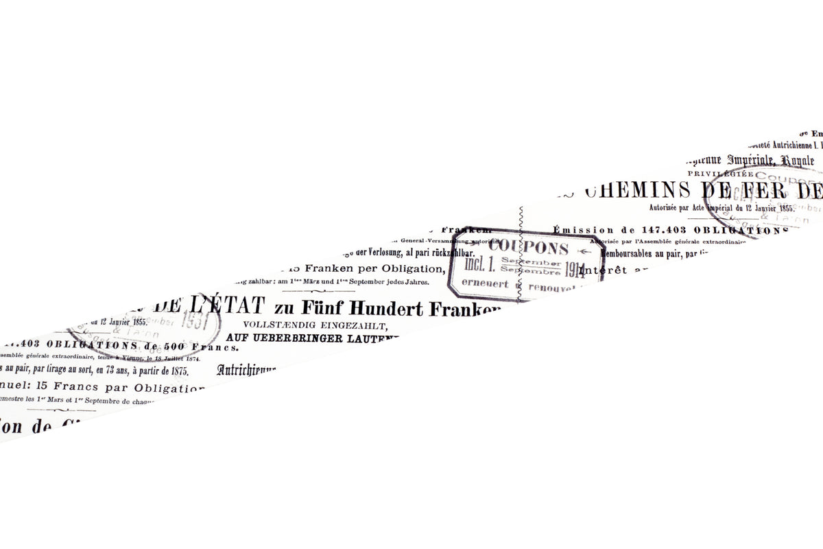 A roll of decorative tape featuring black French text and numbers printed on a white background, shown against a clean white backdrop.
