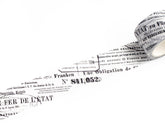 A roll of decorative tape featuring black French text and numbers printed on a white background, shown against a clean white backdrop.