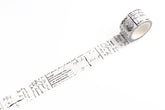 A roll of decorative washi tape with a black script and sketch pattern on a white background, shown partially unrolled on a clean white surface.