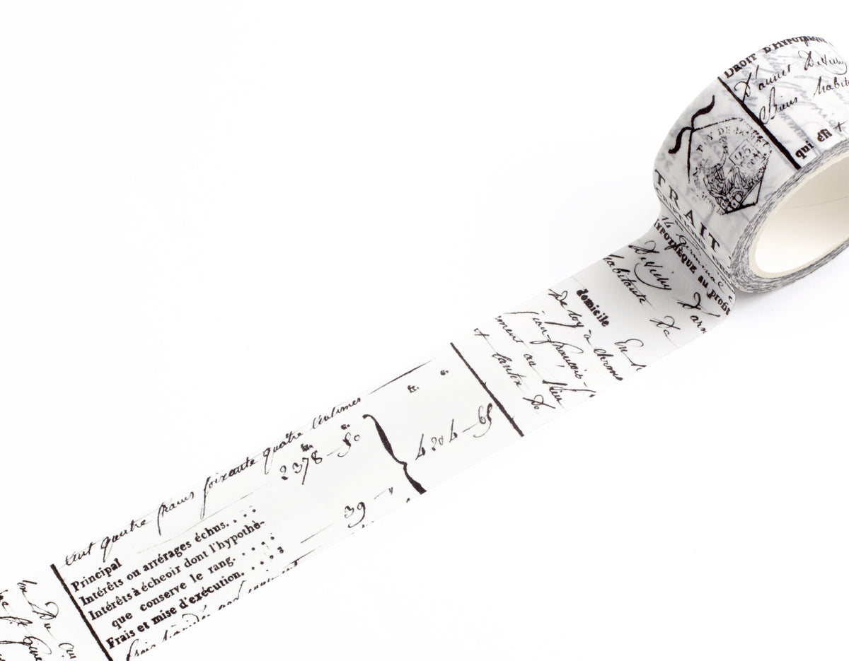 A roll of decorative washi tape with a vintage French script and postmark pattern, partially unrolled on a clean white background.