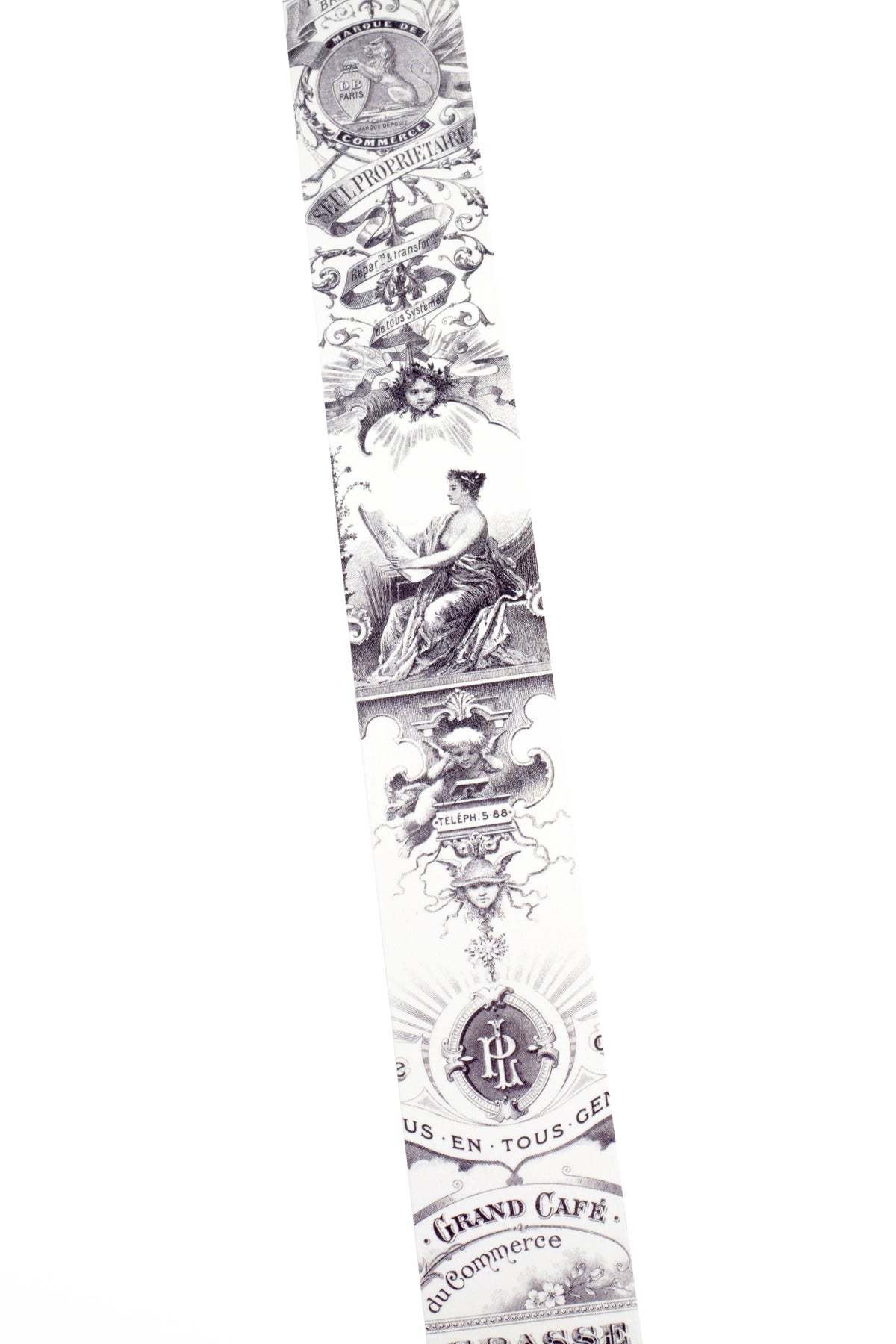 A long washi strip with a repeating black vintage-style ornamental pattern and text, shown against a plain white background.