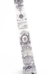 A long washi strip with a repeating black vintage-style ornamental pattern and text, shown against a plain white background.