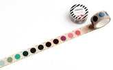 A roll of decorative washi tape with circular color swatches printed on the tape, shown partially unrolled alongside the branded roll on a white background.