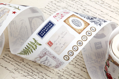 Washi tape with pre-cut vintage-style decorative stickers such as illustrated labels, postage stamps, numbers, and antique typography, laid over a background of old handwritten letters and papers.
