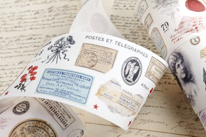 Washi tape with pre-cut vintage-style decorative stickers such as illustrated labels, postage stamps, numbers, and antique typography, laid over a background of old handwritten letters and papers.
