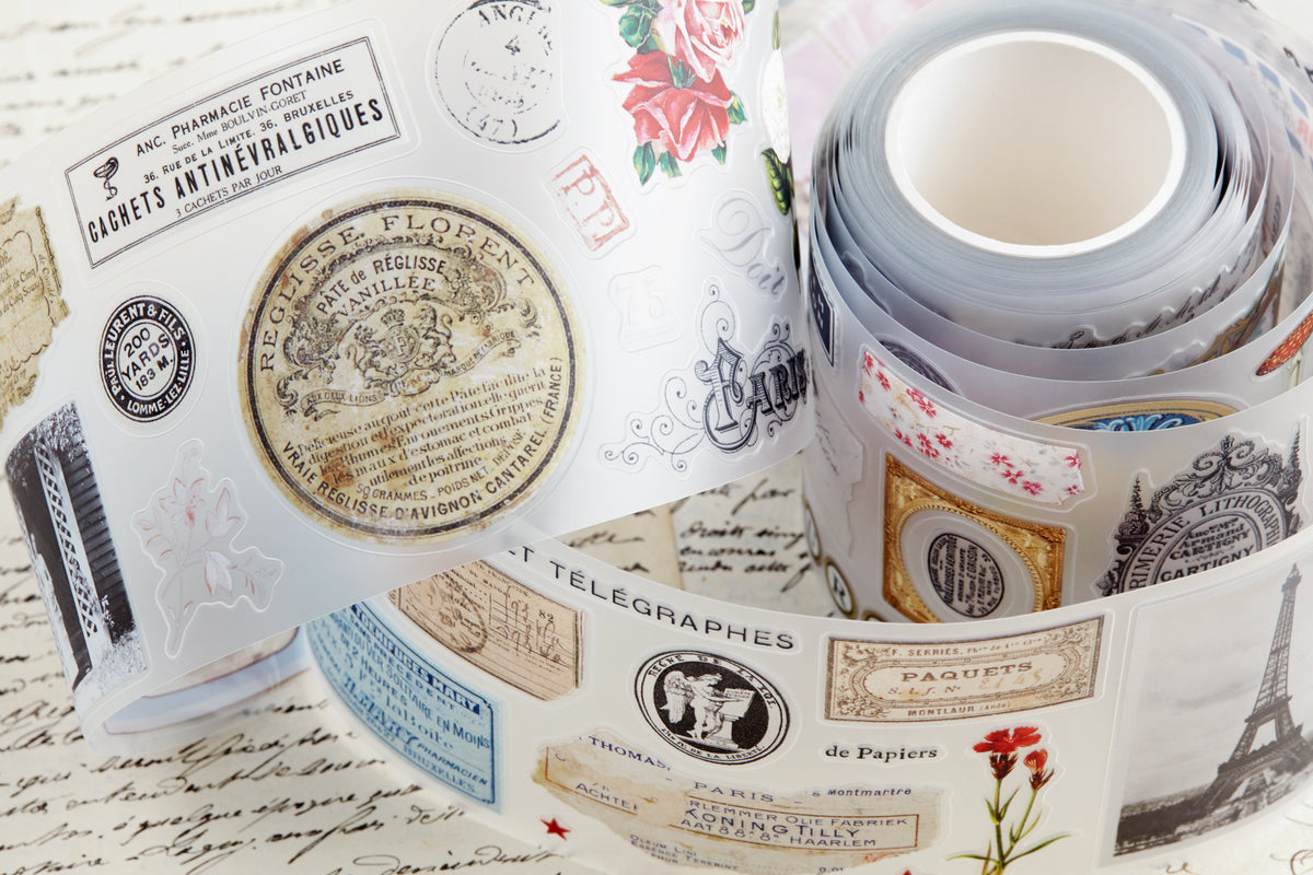 PET tape with pre-cut vintage-style decorative stickers such as illustrated labels, postage stamps, numbers, and antique typography, laid over a background of old handwritten letters and papers.