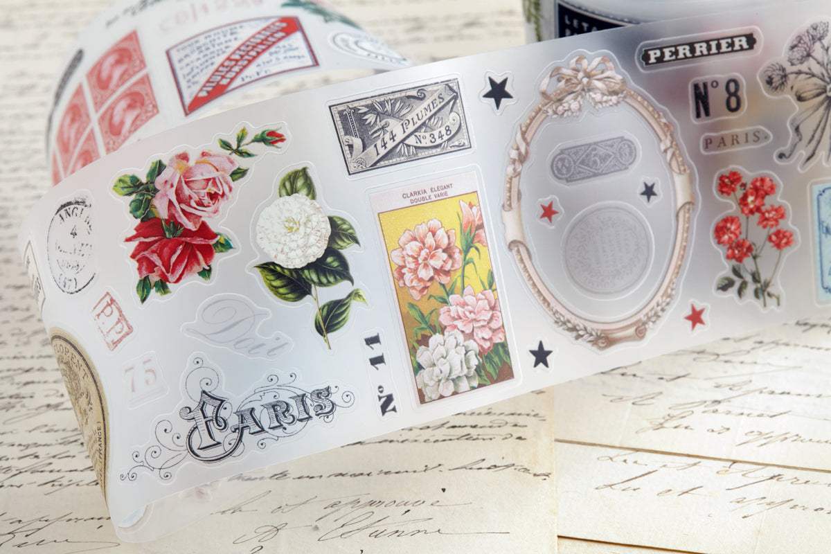 PET tape with pre-cut vintage-style decorative stickers such as illustrated labels, postage stamps, numbers, and antique typography, laid over a background of old handwritten letters and papers.