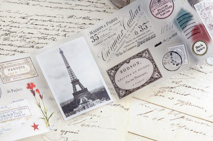 PET tape with pre-cut vintage-style decorative stickers such as illustrated labels, postage stamps, numbers, and antique typography, laid over a background of old handwritten letters and papers.