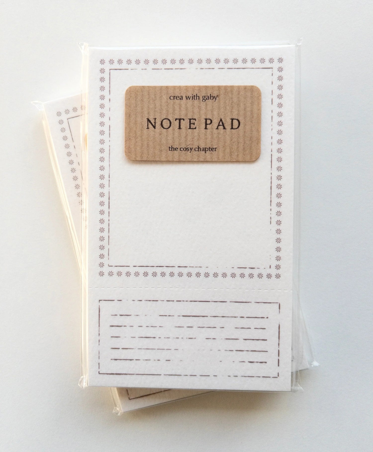 Note pad with a brown label on a white background