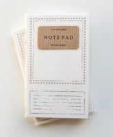 Note pad with a brown label on a white background