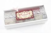 A boxed set of vintage-style washi tapes from The Heirloom Collection, featuring white lace-patterned tapes and a deep red tape, presented in a white gift box with a decorative tag.