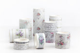 A group of decorative washi tape rolls with vintage floral and geometric patterns, displayed on a clean white background.