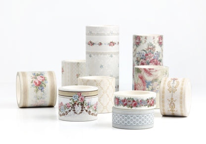 A group of decorative washi tape rolls with floral and geometric patterns, arranged on a clean white background.